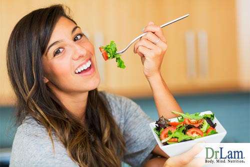 A young woman eating a salad, which big food companies likely contributed to