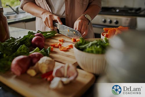 An image of a woman chopping vegetables on a cutting board