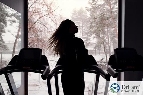 An image of a woman on a treadmill getting her winter exercise indoors
